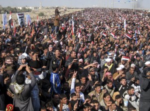 Protesters chant slogans against the Iraq's Shiite-led government as they wave national flags during a demonstration in Fallujah, 40 miles (65 kilometers) west of Baghdad, Iraq, Friday, Jan. 4, 2013. About 3,000 people gathered in the northern city of Mosul, where they called for the release of female prisoners and to end to what they say are random arrests of Sunnis. Among their chants were: "Down, down with al-Maliki" and "No to sectarianism." In the ethnically mixed city of Kirkuk, about 1,000 protested to demand the release of Sunni detainees. Protests were also reported in the Sunni strongholds of Fallujah and Tikrit. (AP Photo)